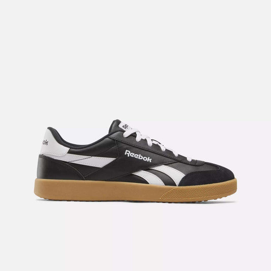 The Reebok Smash Edge Shoes are black and white sneakers with a minimalist design, white laces, a white Reebok logo, and a light brown rubber sole, shown in side profile against a plain white background.