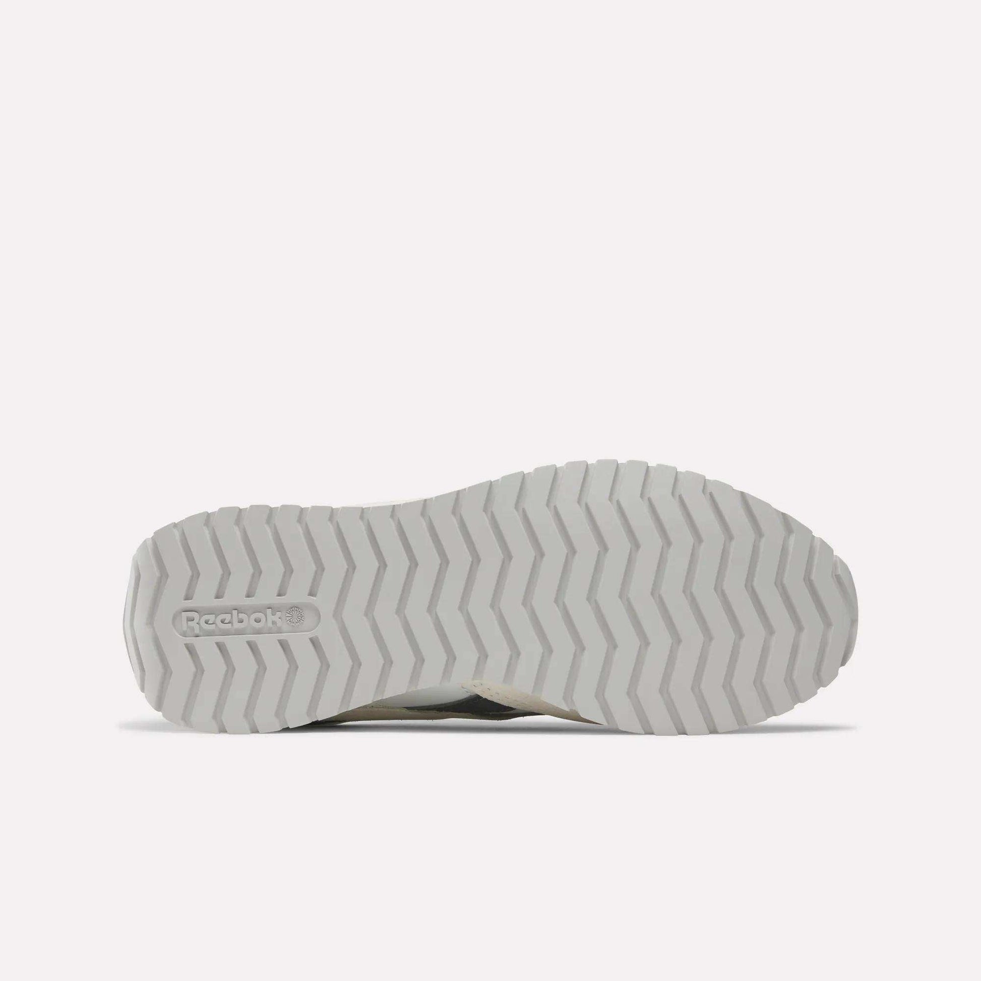 Bottom view of Women's Classic AZ Shoes by Reebok, featuring a white sole with zigzag tread and Reebok logo on the heel, shown against a light background—perfect vintage-inspired running shoes for women.