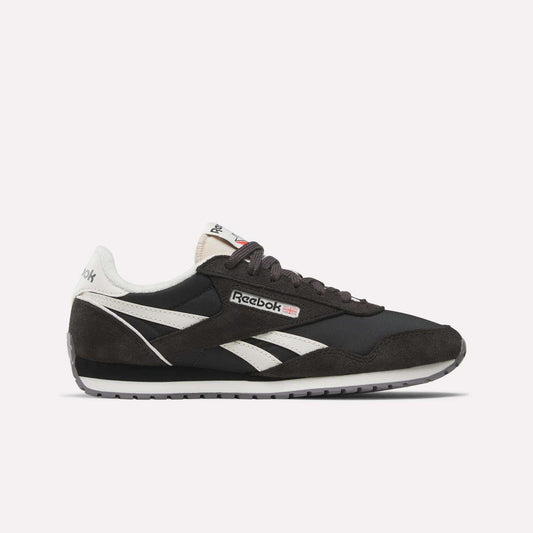 The Reebok Women's Classic AZ Shoes feature black and white suede and leather details, signature white side stripes, a black sole, and the Reebok logo on the side and tongue—all shown against a plain white background.