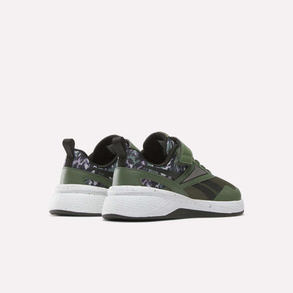 The Reebok Nano Play Stretch Lace And Top Strap Shoes for little kids are shown from the back in green with black and dark camo details, white soles, and black pull tabs—perfect as boys' training shoes in a kid-sized Nano style.