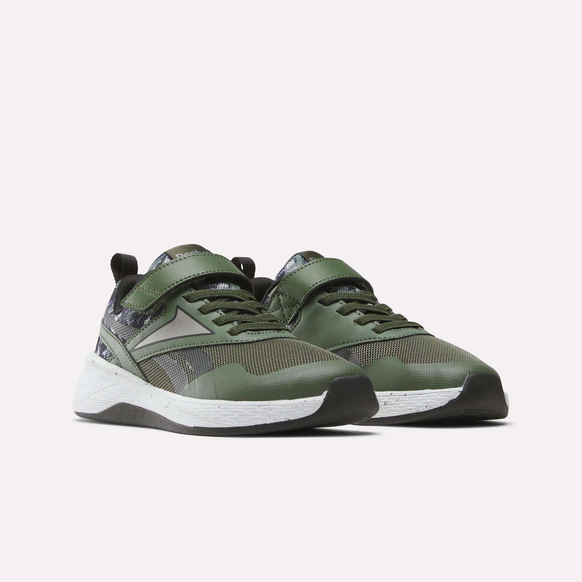 The Reebok Nano Play Stretch Lace And Top Strap Shoes for little kids are green training shoes with black and white accents, mesh panels, a patterned heel, white midsoles, black outsoles, and Velcro straps—ideal for active boys.