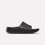 A single Reebok DMX Recovery Walking Slide in black, featuring a textured ridged design, thick sole, super-soft foam, and open toe, is displayed against a plain white background.