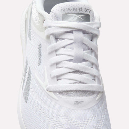 Close-up of a white Reebok Women's Nano X5 Training Shoe viewed from above, featuring visible laces, the Reebok logo on the tongue, mesh fabric details, and branding that highlights these comfortable training shoes.