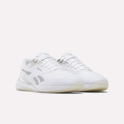 A pair of Reebok Women's Nano X5 Training Shoes in white with gray accents, mesh uppers, and translucent outsoles are displayed side by side on a plain white background.