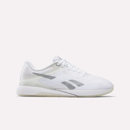 The Reebok Women's Nano X5 Training Shoes are comfortable white sneakers with light gray accents, a textured sole, and the Reebok logo on the side—stylish and perfect for any workout. Shown in side profile against a plain white background.
