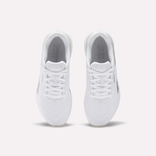 A pair of comfortable white Reebok Women's Nano X5 Training Shoes viewed from above on a plain light background, highlighting the laces, mesh texture, and Reebok branding on the insoles.