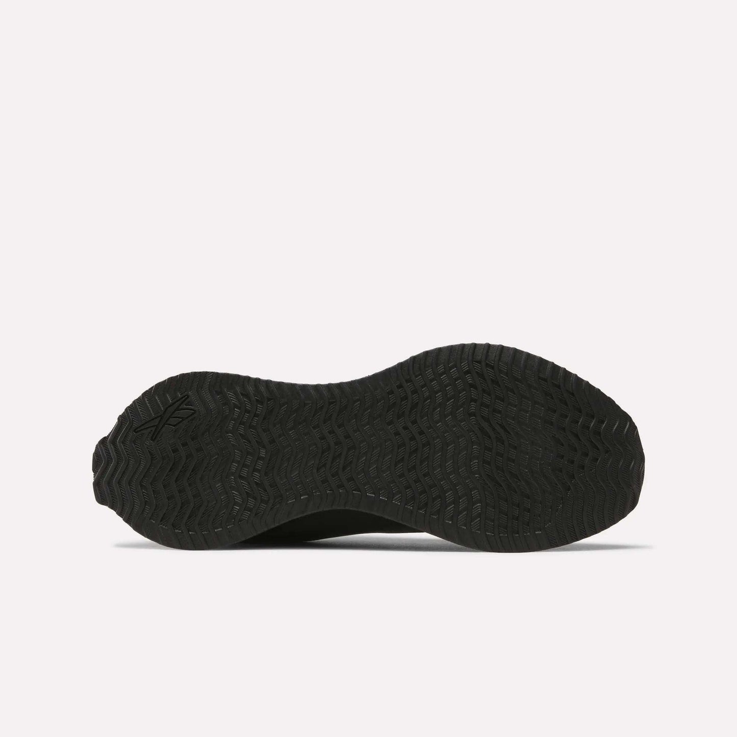 The image displays the black, textured rubber outsole of Reebok Zig Dynamica STR Shoes seen from underneath, featuring a wavy geometric tread pattern made for enhanced grip.