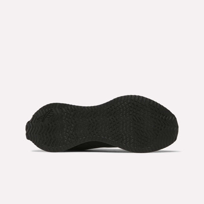The image displays the black, textured rubber outsole of Reebok Zig Dynamica STR Shoes seen from underneath, featuring a wavy geometric tread pattern made for enhanced grip.