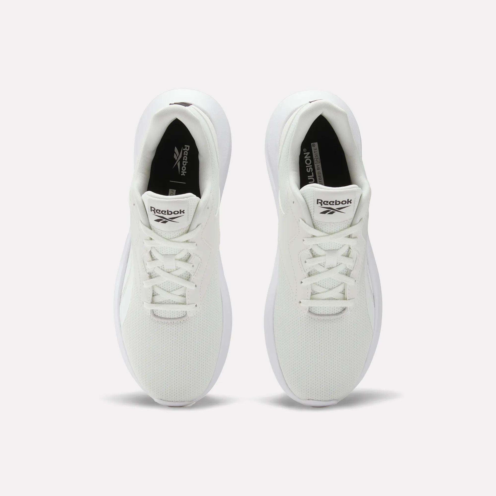 Top view of Reebok Men's Energen Lux Running Shoes with white laces and mesh texture, placed side by side on a plain light background.