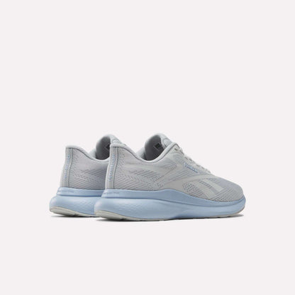 A pair of Women's Energen Run 4 Running Shoes by Reebok in light gray with breathable mesh uppers and light blue soles and laces, shown from the back and side against a white background.