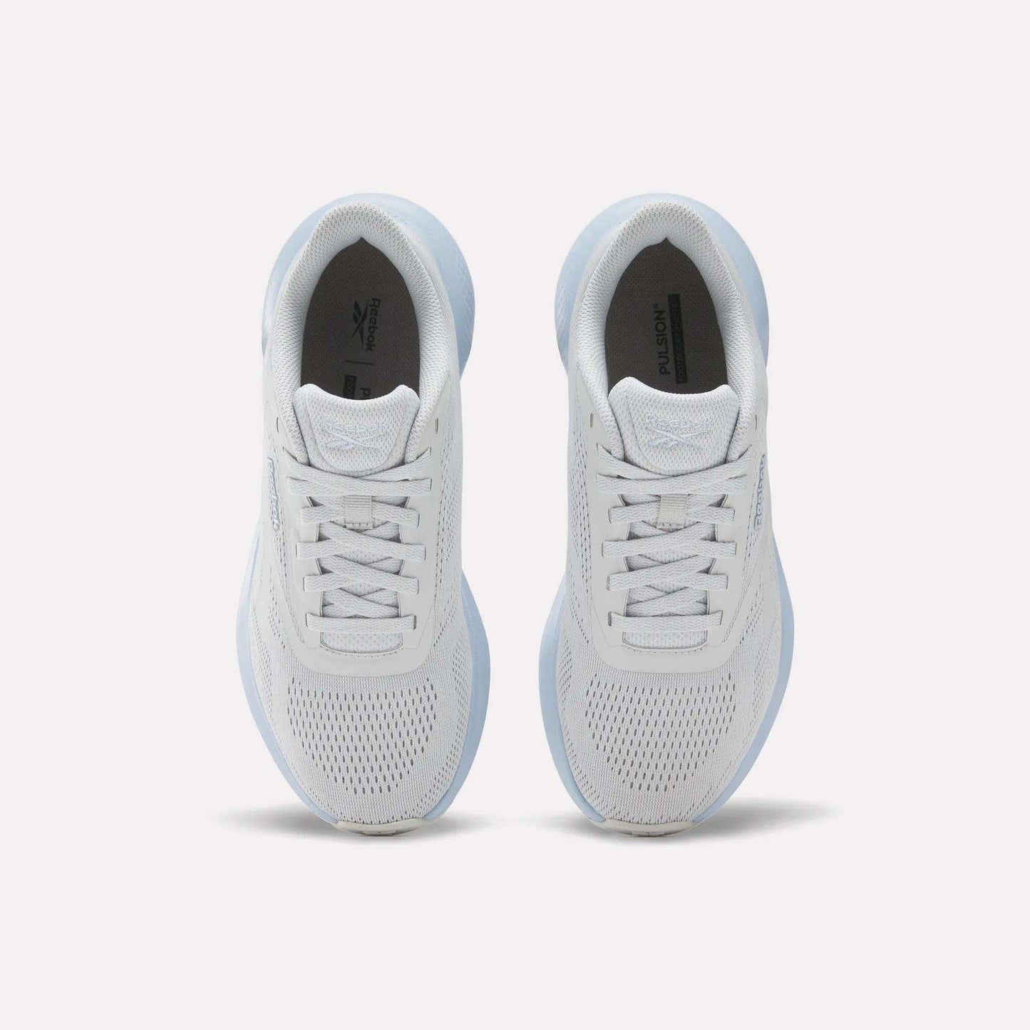 Top view of Reebok Women's Energen Run 4 Running Shoes featuring breathable mesh uppers and laces, placed side by side on a light background.