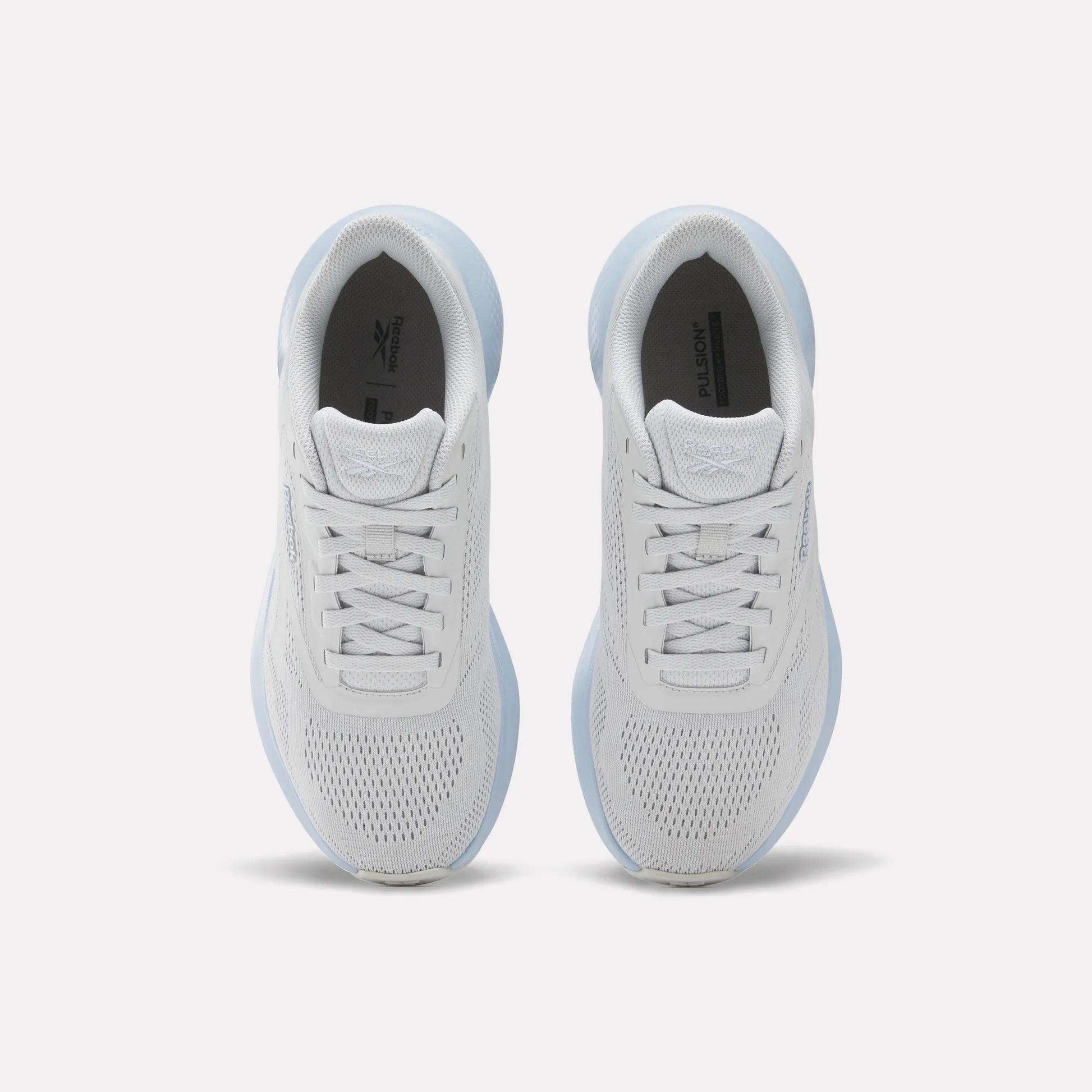 Top view of Reebok Women's Energen Run 4 Running Shoes featuring breathable mesh uppers and laces, placed side by side on a light background.