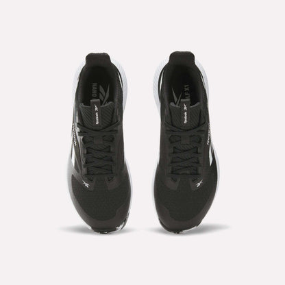 Top view of a pair of black Reebok Nano Golf Shoes with white soles, performance foam cushioning, and Reebok branding on the tongues and sides, positioned side by side on a white background.