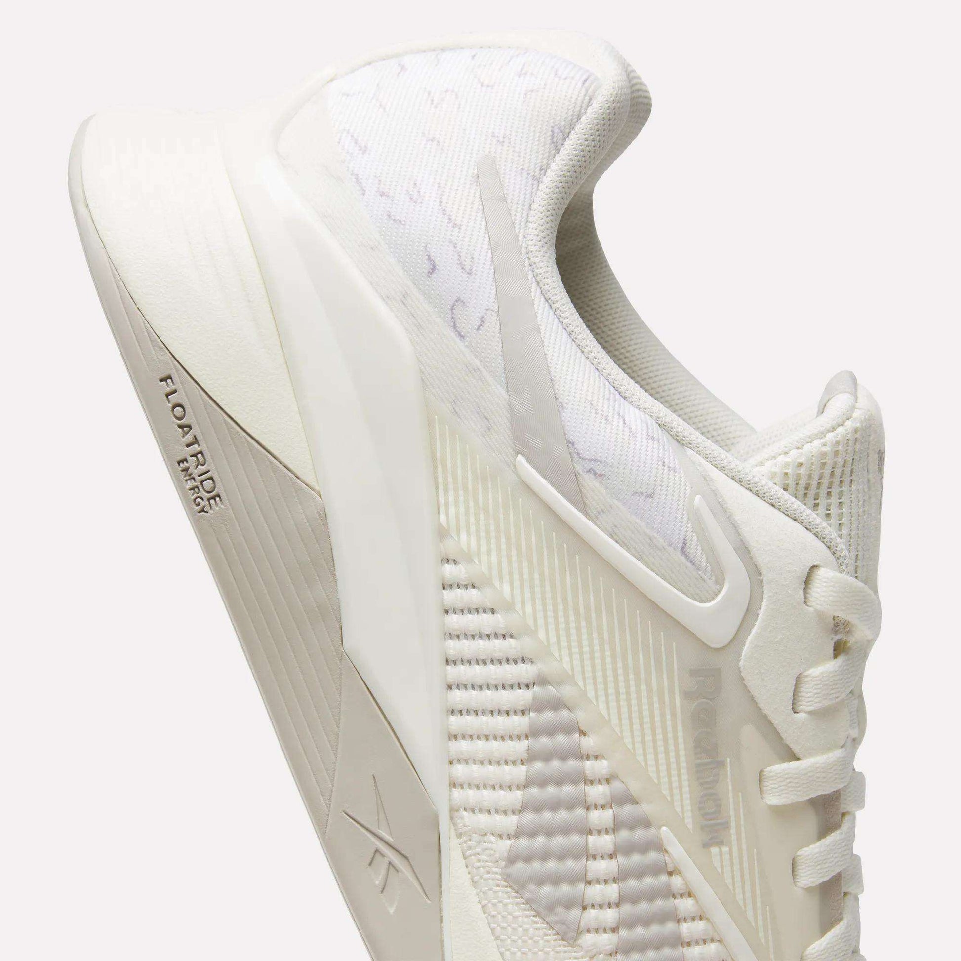 A close-up of Reebok Nano X4 Training Shoes in off-white, featuring breathable mesh panels, textured fabric, laces, and "FLOATRIDE" on the midsole. The shoe's modern design ensures a lightweight feel for training sessions.
