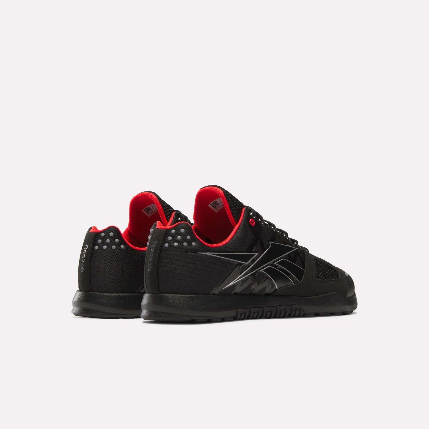 A pair of Reebok Men's Nano 2.0 Training Shoes in black with red interiors and white heel and logo accents are displayed on a white background—one facing forward, the other angled outward—ideal for functional fitness workouts.