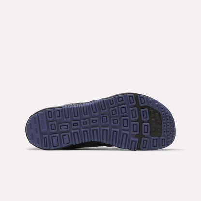 The image displays the bottom view of Reebok Women's Nano 2.0 Training Shoes, featuring a purple rubber sole with a grid-like tread and black accents on the toe and heel, designed for functional fitness. Background is plain white.