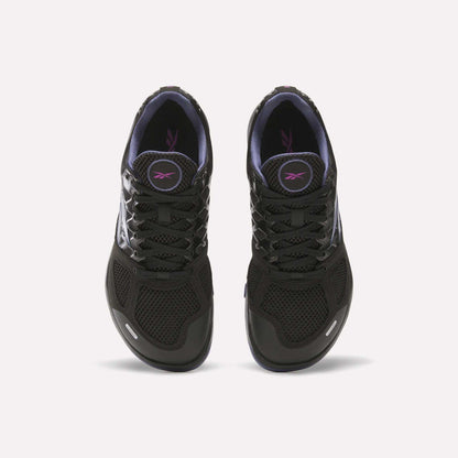 A pair of Women's Nano 2.0 Training Shoes by Reebok in black with black laces, purple lining, and a purple logo on the tongue, designed for functional fitness and shown from above on a white background.
