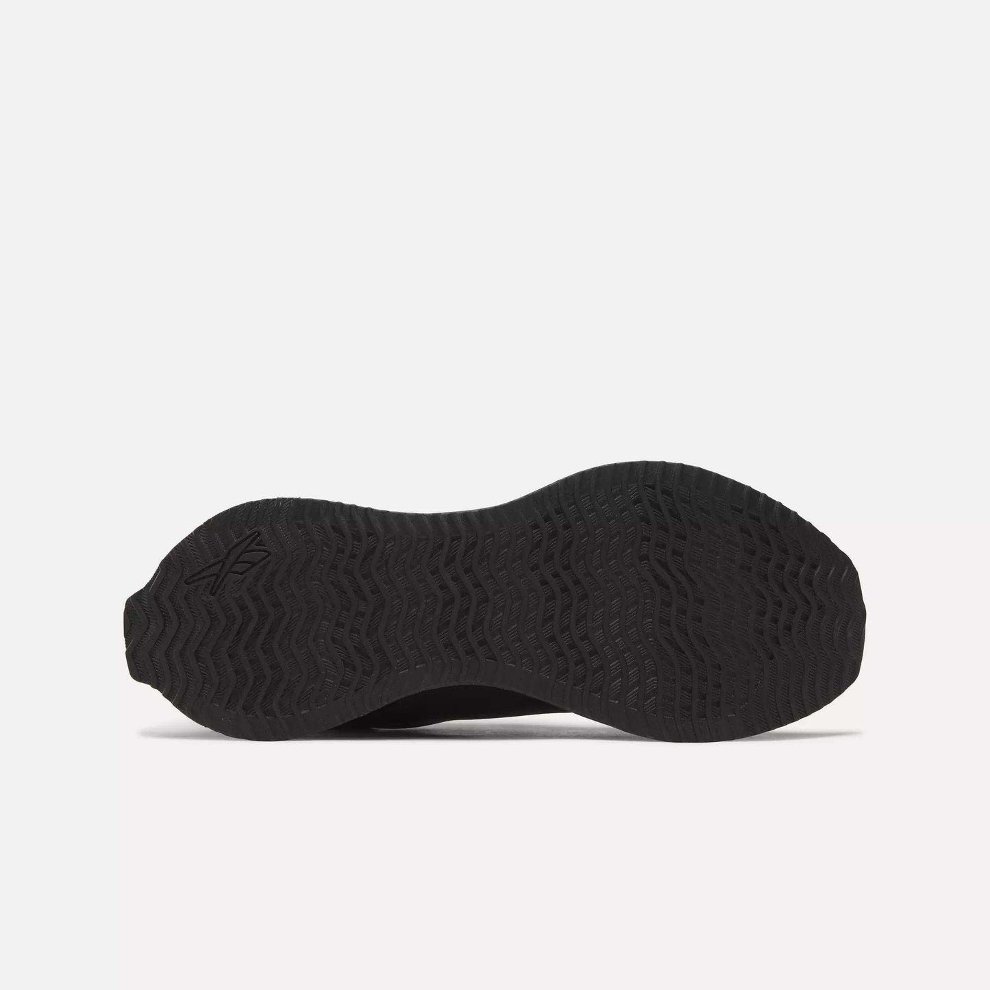 Bottom view of the Reebok Zig Dynamica STR Shoes in black, featuring a textured rubber sole with wave and zigzag tread pattern, FuelFoam midsole cushioning, and a subtle logo by the heel—engineered for progressive running performance.