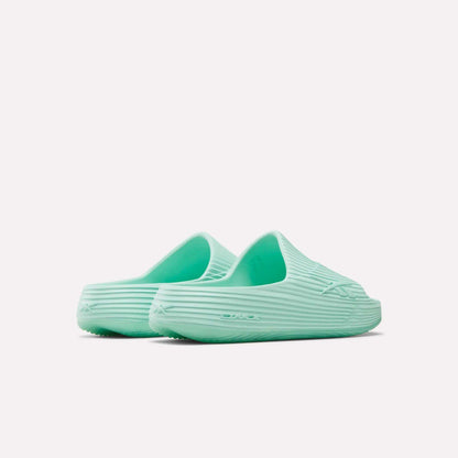 A pair of mint green Reebok DMX Recovery Walking Slides with a textured ribbed design and moving air cushioning, shown from the back and side on a plain white background.