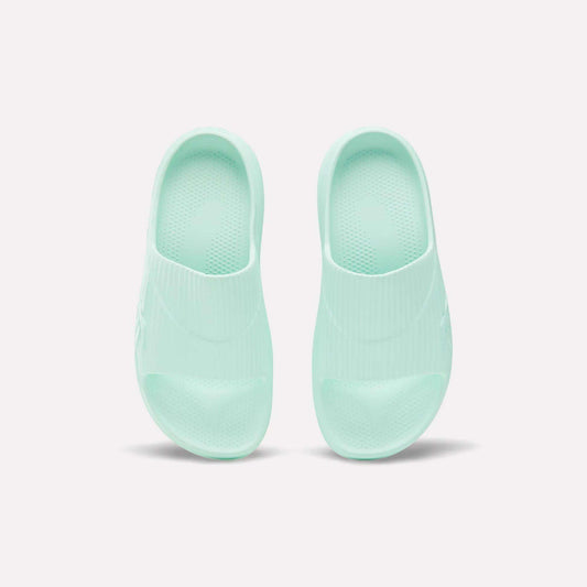 A pair of mint green Reebok DMX Recovery Walking Slides, made with super-soft foam, shown from above on a plain white background.