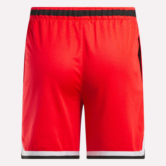 Reebok Men's Basketball Transition Shorts 7" in red feature a black waistband, white and black trim at the hem, and breathable perforated mesh fabric; shown from the back.