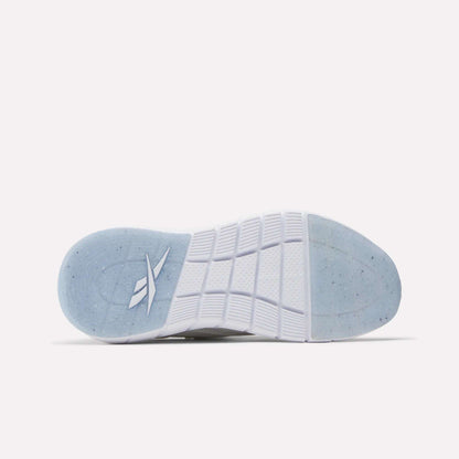 The image shows the bottom view of a white Women's Nano Gym Training Shoe sole by Reebok, featuring a translucent blue heel section with a stylized logo and textured tread for grip—perfect for fitness or cross-training.