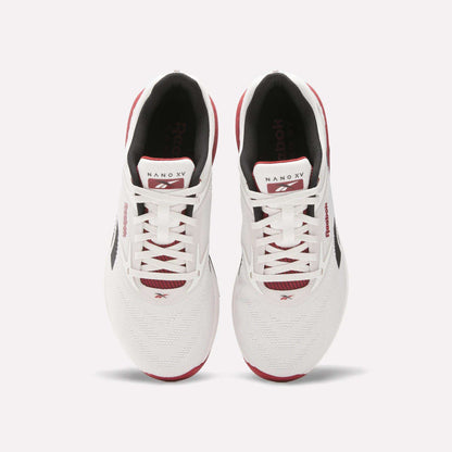 A pair of white Reebok Nano X5 training shoes with red and black accents, viewed from above, featuring laces, branded tongue, and mesh toe boxes against a light background. Perfect men’s workout shoes from Reebok.