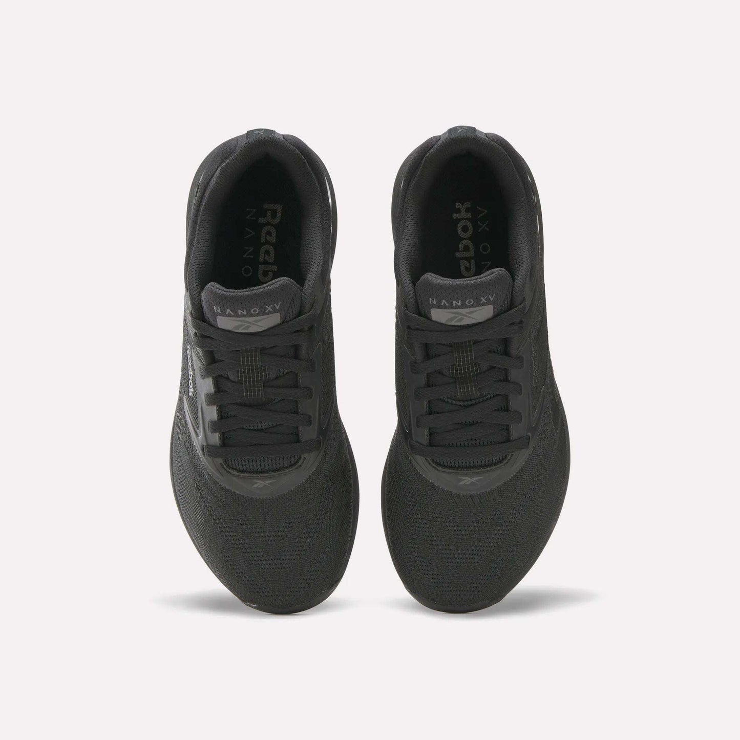 Top view of a pair of black Reebok Women's Nano X5 Training Shoes with black laces and NANO X5 on each tongue, placed side by side on a white background; ideal for women seeking both style and performance.