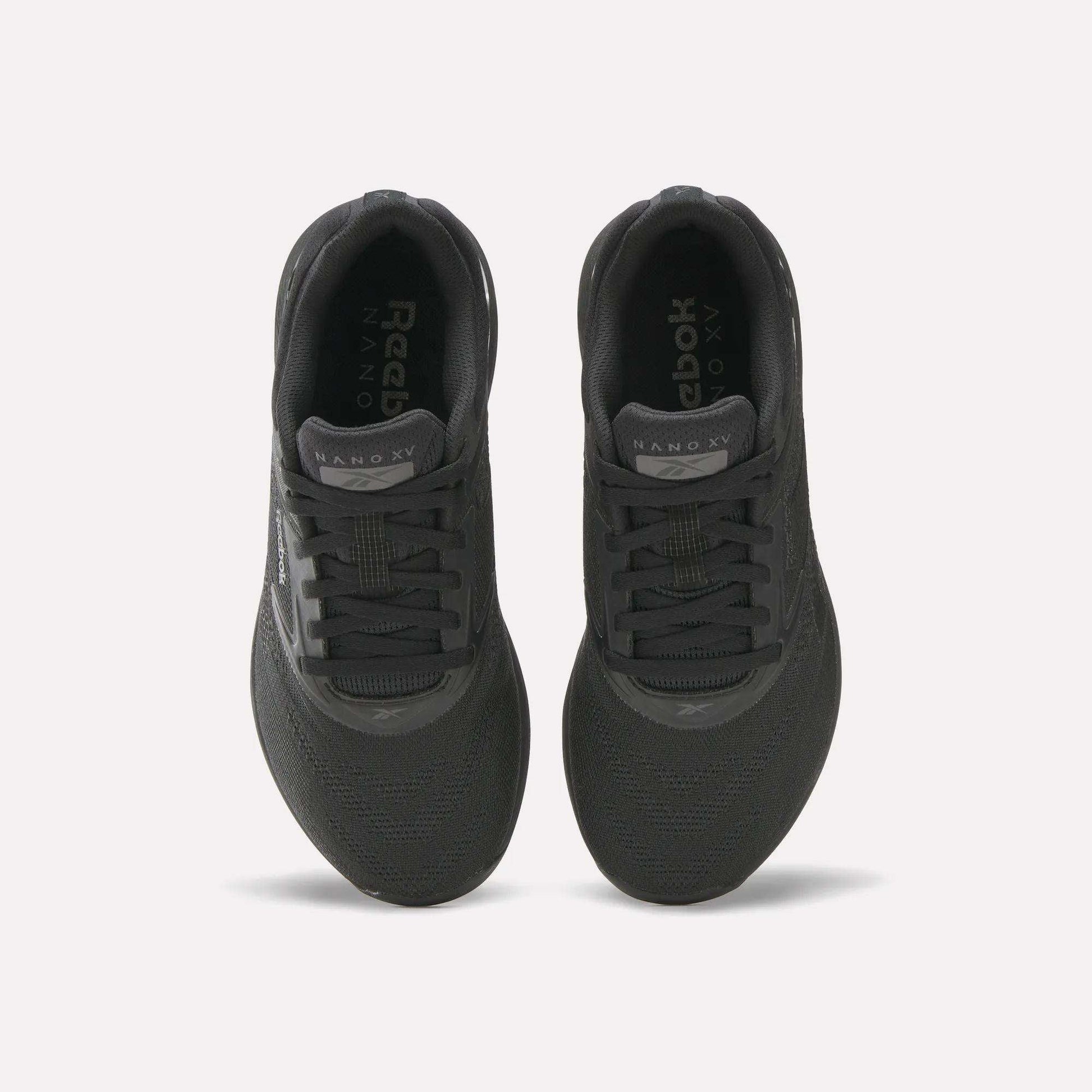 Top view of a pair of black Reebok Women's Nano X5 Training Shoes with black laces and NANO X5 on each tongue, placed side by side on a white background; ideal for women seeking both style and performance.