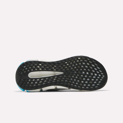 The image shows the sole of the Reebok Men's FloatZig 2 Running Shoes, mainly black with a grid-like tread and white and blue accents. A midfoot cut-out reveals the shoe’s energy-returning Superfloat+ cushioning.