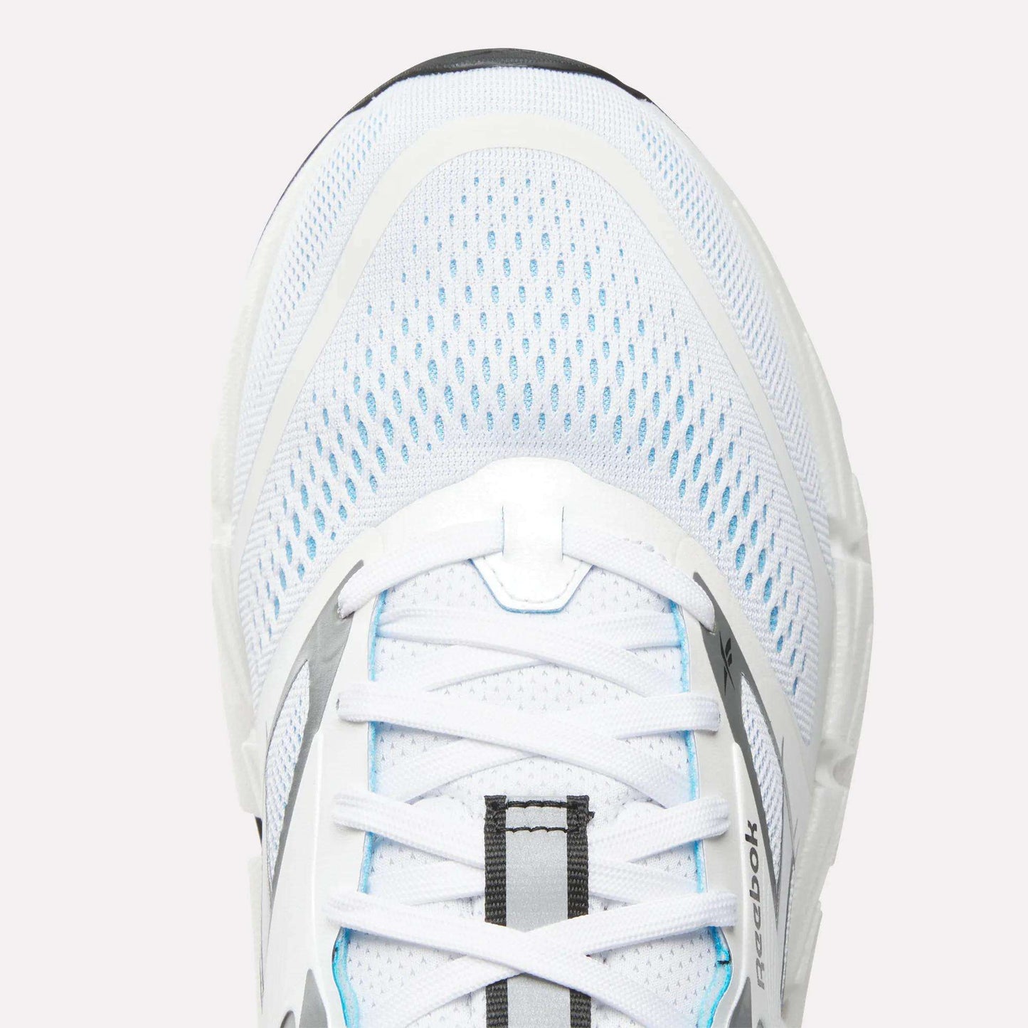 Close-up of the top of a white Reebok Men's FloatZig 2 Running Shoe with light blue accents, mesh upper, white laces, Superfloat+ cushioning, and the Reebok logo visible on the side.