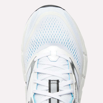 Close-up of the top of a white Reebok Men's FloatZig 2 Running Shoe with light blue accents, mesh upper, white laces, Superfloat+ cushioning, and the Reebok logo visible on the side.