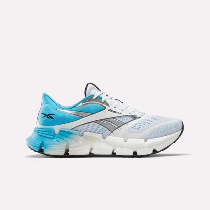 The Reebok Men's FloatZig 2 Running Shoes are displayed from the side, featuring a light blue and white design with a silver logo, mesh upper, and energy-returning Superfloat+ cushioning against a plain white background.