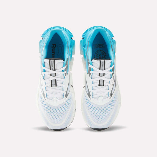 Top view of Reebok Men's FloatZig 2 Running Shoes with white mesh uppers, light blue accents, Superfloat+ cushioning, and black sole details—arranged side by side on a plain white background.