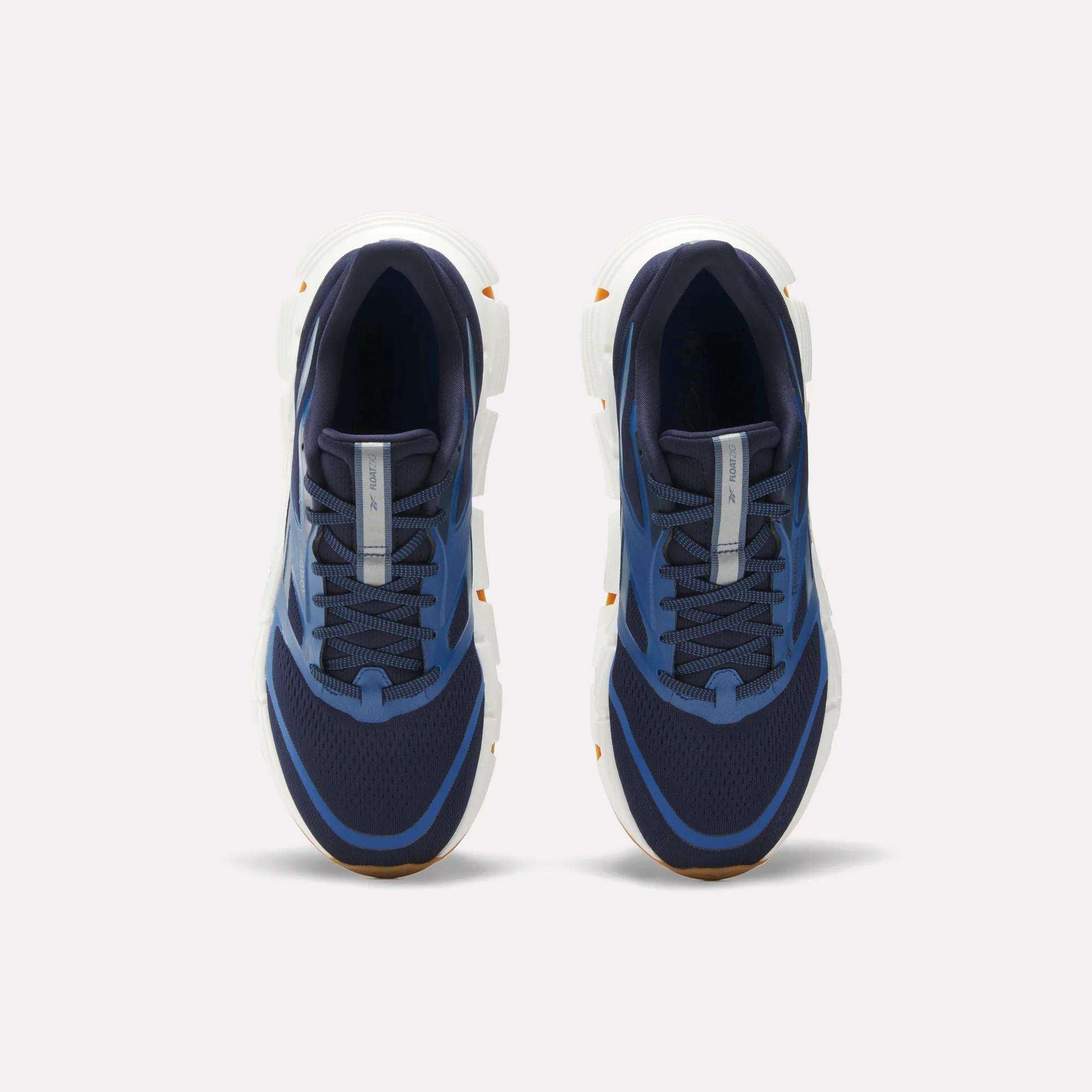 Reebok Men's FloatZig 2 Running Shoes in navy blue with white soles, mesh uppers, and light blue accents. Features Superfloat+ cushioning. Shown from a top-down view on a plain white background.