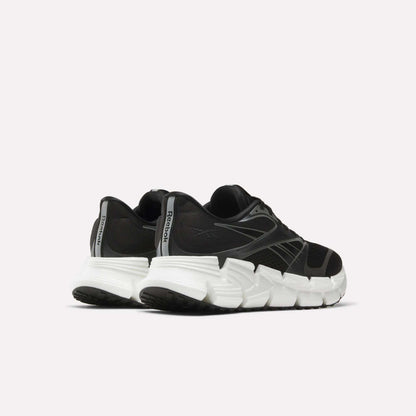 The men's Reebok FloatZig 2 running shoes in black feature chunky white soles and Superfloat+ cushioning, displayed from back and side angles against a plain light background.