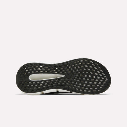 Close-up of the black, white, and gray sole on Reebok Men's FloatZig 2 Running Shoes, showing a textured grid tread pattern and Superfloat+ cushioning, set against a plain white background.
