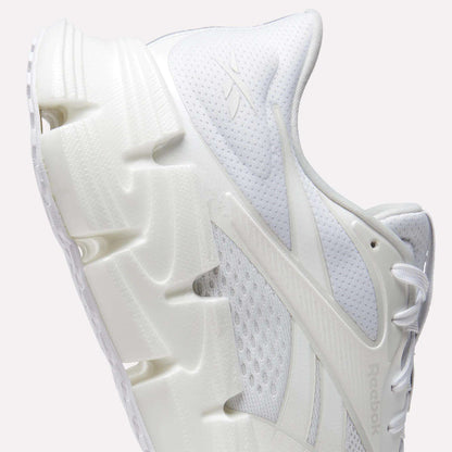 A close-up side view of the Reebok Men's FloatZig 2 Running Shoes, featuring a chunky sculpted sole, mesh upper, energy-returning cushioning, intricate panel details, and the iconic Reebok logo—ideal for running enthusiasts.