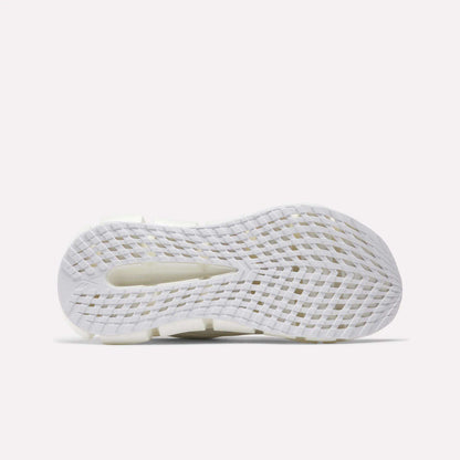 The image displays the white, textured sole of Reebok Women's FloatZig 2 Running Shoes. It features a grid-like traction pattern, a heel cutout, and Superfloat+ cushioning against a plain light background.