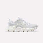 The Reebok Women's FloatZig 2 Running Shoes feature a white breathable mesh upper, tonal laces, and a sculpted rubber sole with Superfloat+ cushioning, shown in side profile on a plain white background.