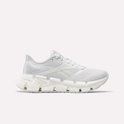The Reebok Women's FloatZig 2 Running Shoes feature a white breathable mesh upper, tonal laces, and a sculpted rubber sole with Superfloat+ cushioning, shown in side profile on a plain white background.