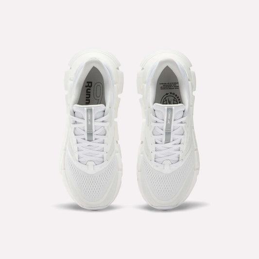 A pair of Women's FloatZig 2 Running Shoes by Reebok viewed from above, featuring white mesh uppers, chunky Superfloat+ cushioned soles, and white laces. The insoles show Reebok branding and graphic details.