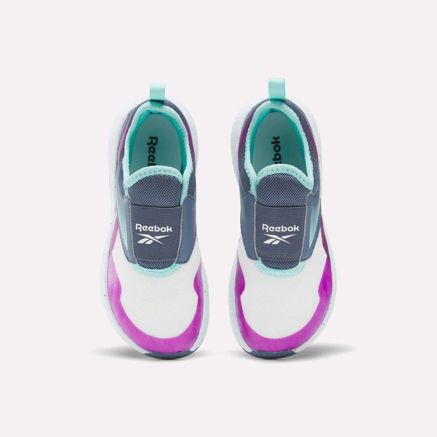 Top view of Kids' Nano Play Slip-on by Reebok—these kid-sized sneakers feature white mesh uppers with turquoise, purple, and navy accents plus light blue heel tabs.