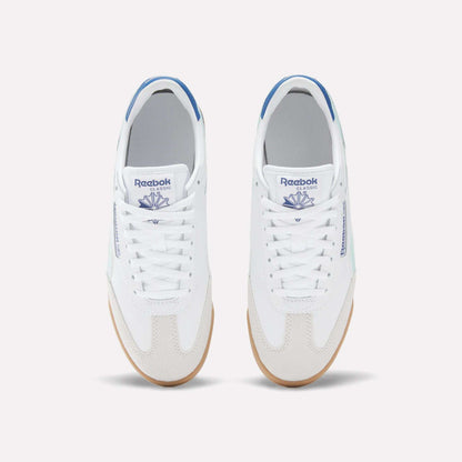 A pair of white Reebok Campio XT Shoes for Big Kids with blue accents, seen from above. These leather sneakers feature white laces, gum soles, and the blue Reebok logo on the tongue and side.