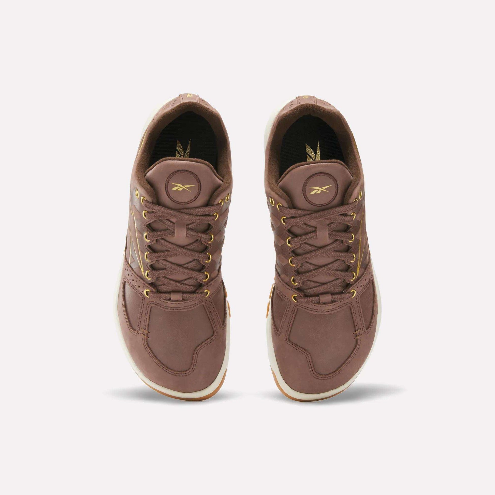 A pair of Reebok Nano 2.0 Training Shoes in brown pebbled leather with gold eyelets and laces, seen from above against a plain light background.