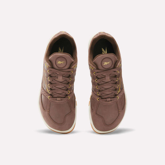 A pair of Reebok Nano 2.0 Training Shoes in brown pebbled leather with gold eyelets and laces, seen from above against a plain light background.