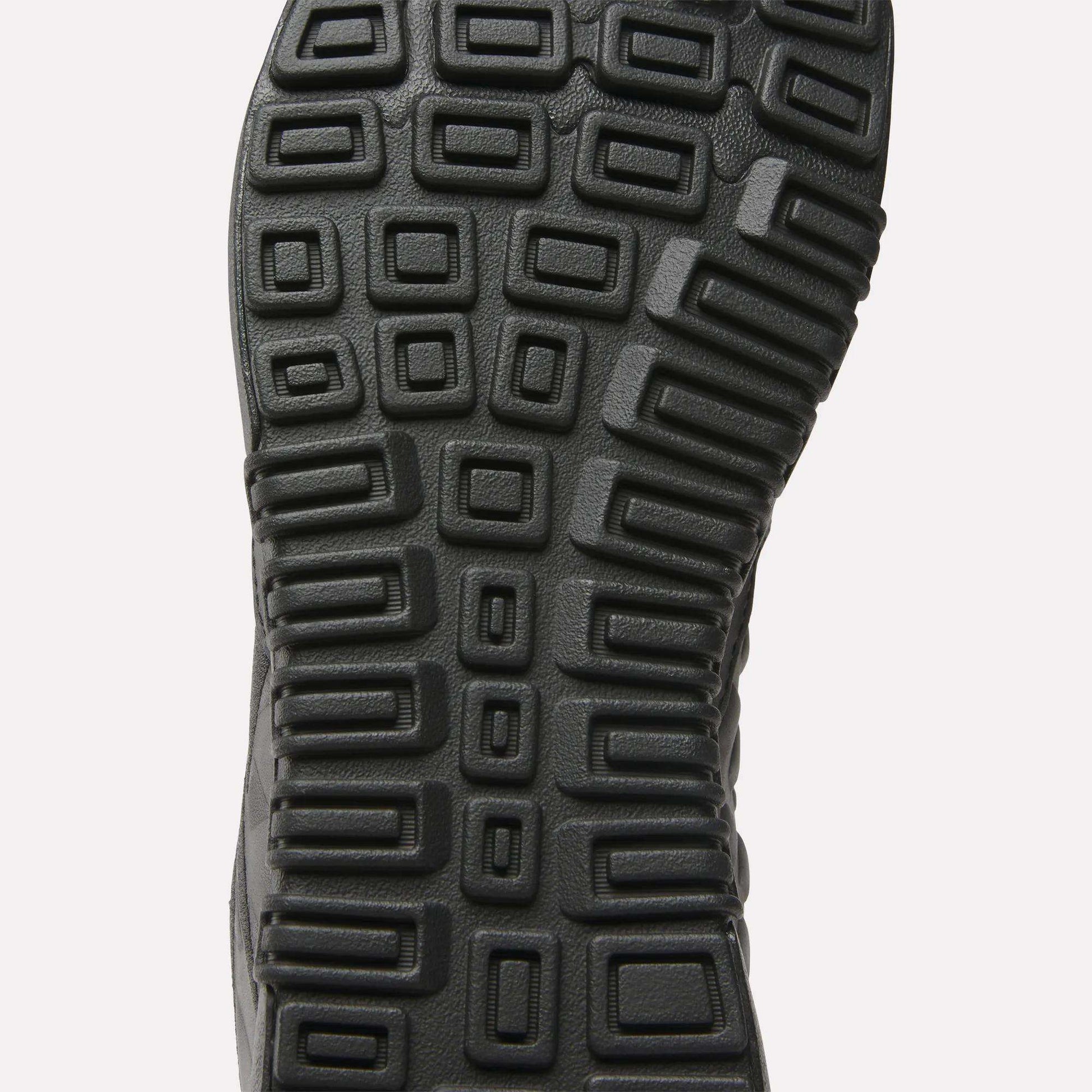 Close-up of the Reebok Nano 2.0 Training Shoes’ black sole, featuring a textured pattern of raised squares and rectangles for superior traction and grip—ideal for peak performance.
