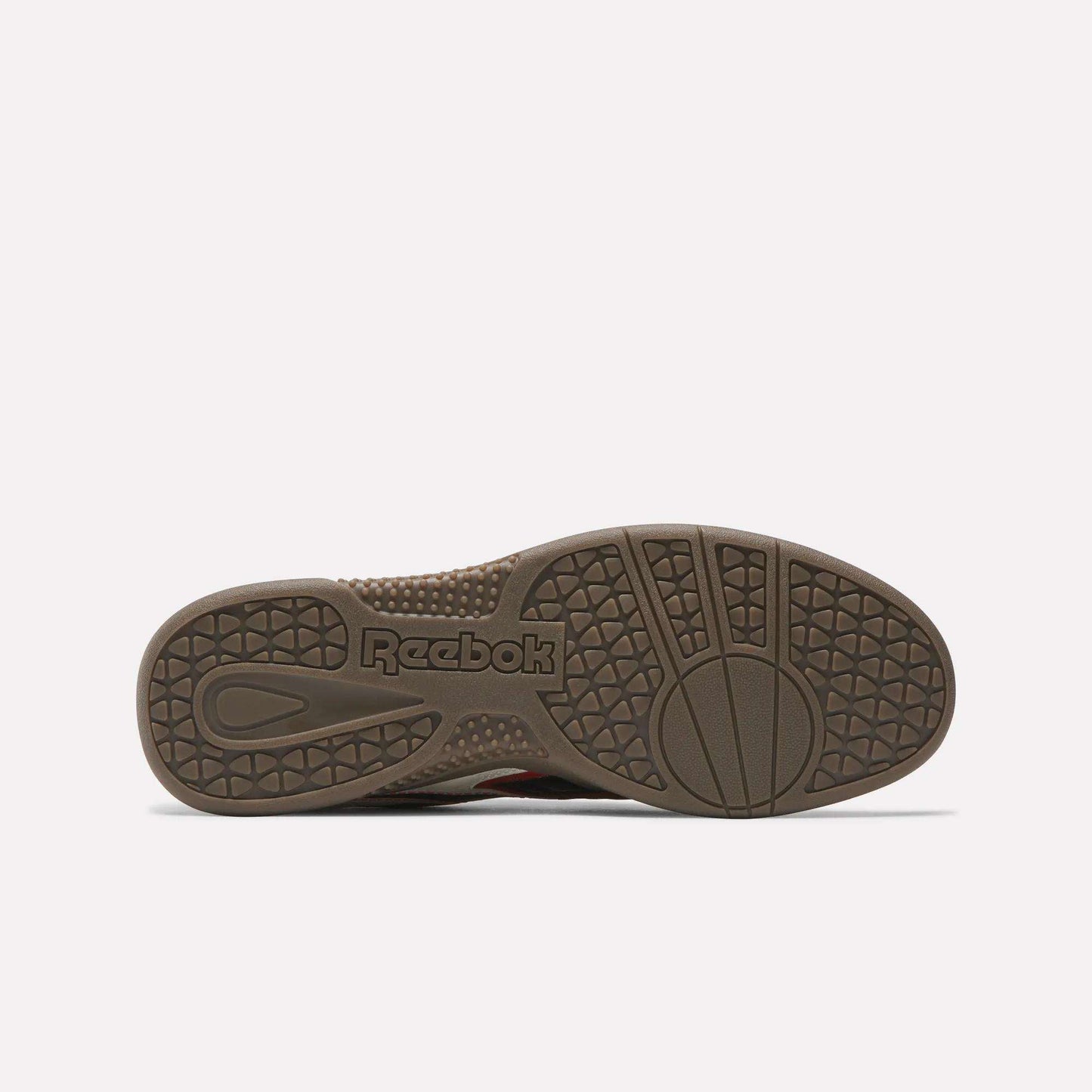 The image shows the brown outsole of Reebok Hammer Valde Shoes from the bottom, featuring textured grip patterns, circular designs, and the embossed Reebok logo near the heel, complementing its classic leather upper.