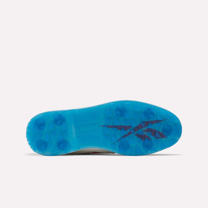 The image shows the bottom view of Reebok Question Golf Shoes, featuring a bright blue cleated sole and a dark angular logo design near the arch.
