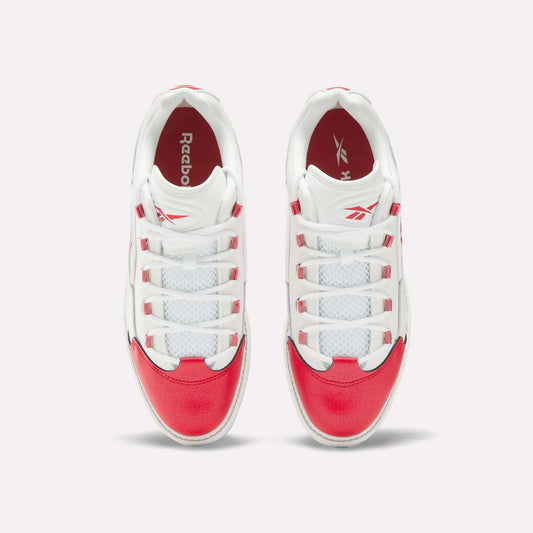 A pair of Reebok Question Golf Shoes viewed from above, showcasing white uppers with bright red accents on the toe, heel, and sides—these stylish spikeless shoes feature white laces threaded through red and white eyelets.